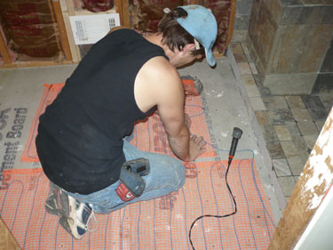 Brandon Dickie installing a heated floor