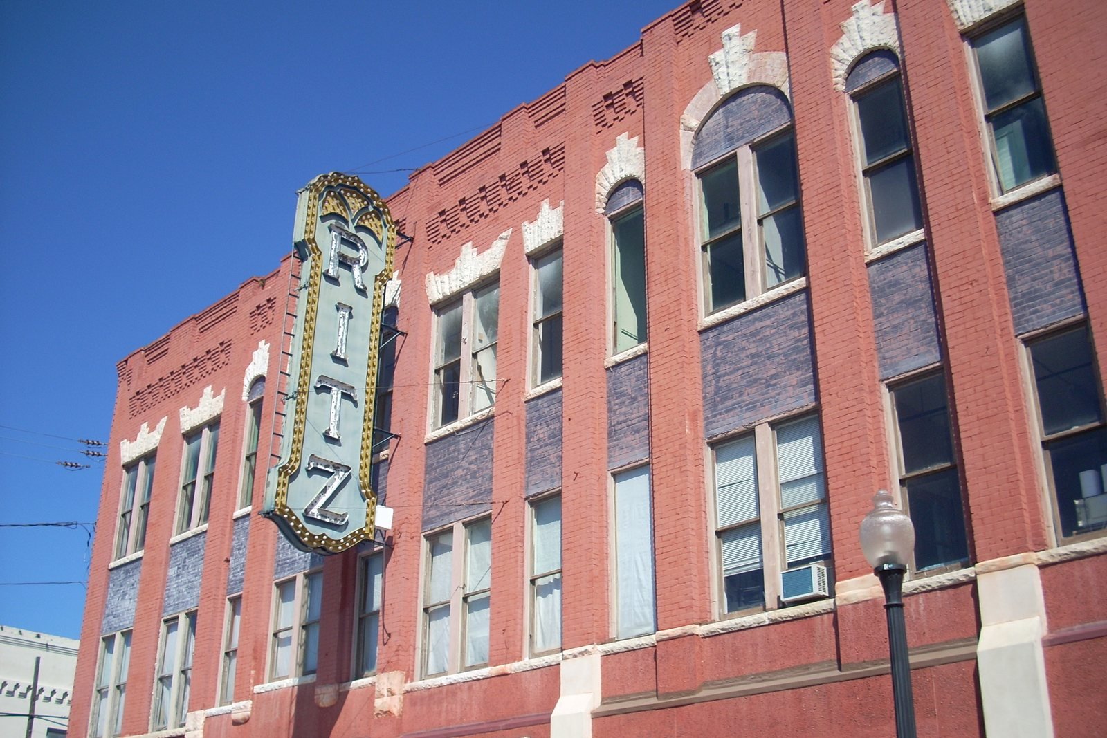 The red brick Ritz Theatre and its vertical neon sign in downtown Brunswick