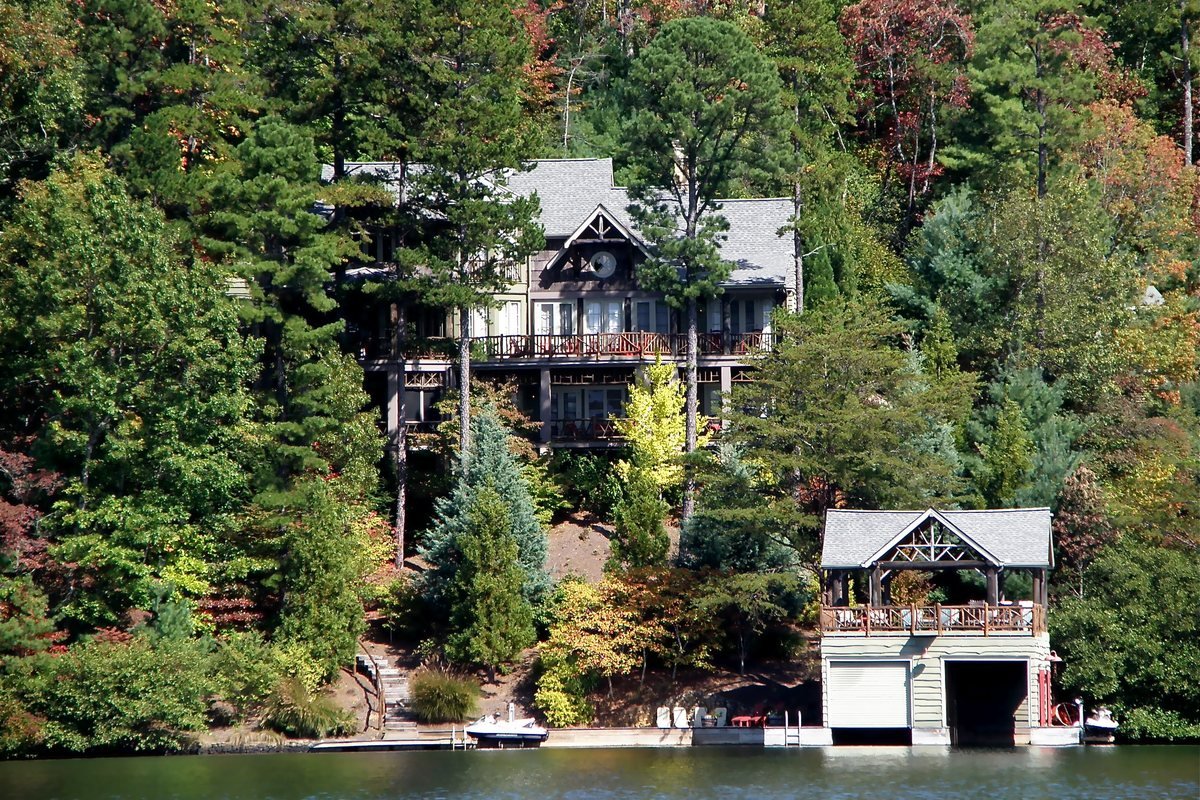 A mountain home and boathouse among fall color on the shore of Lake Burton in Rabun County