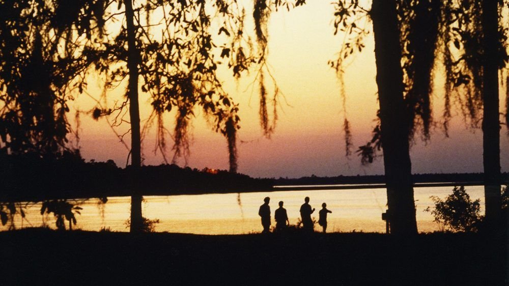 Sunset over the water through Spanish moss-draped oaks at Crooked River State Park