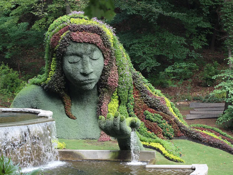 The Earth Goddess plant sculpture with water flowing from her hand at the Atlanta Botanical Garden