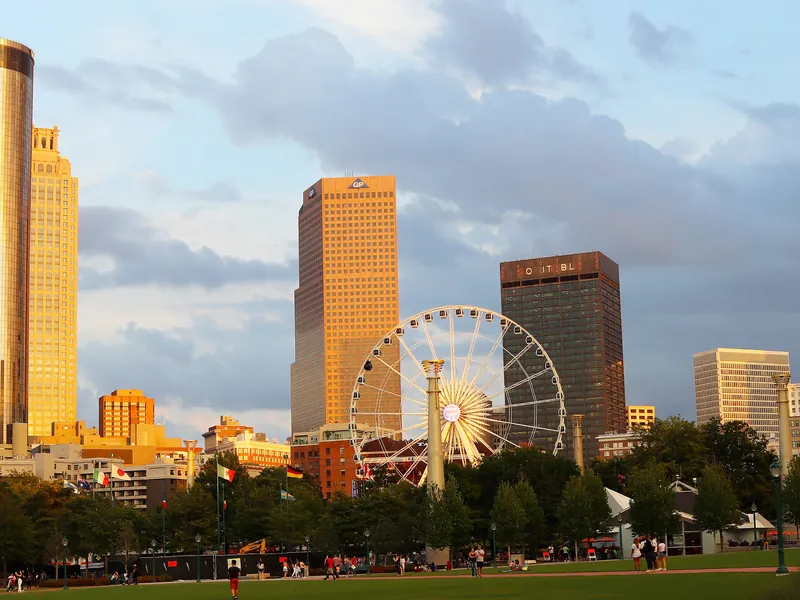 Centennial Olympic Park lawn with SkyView Atlanta and downtown towers at golden hour