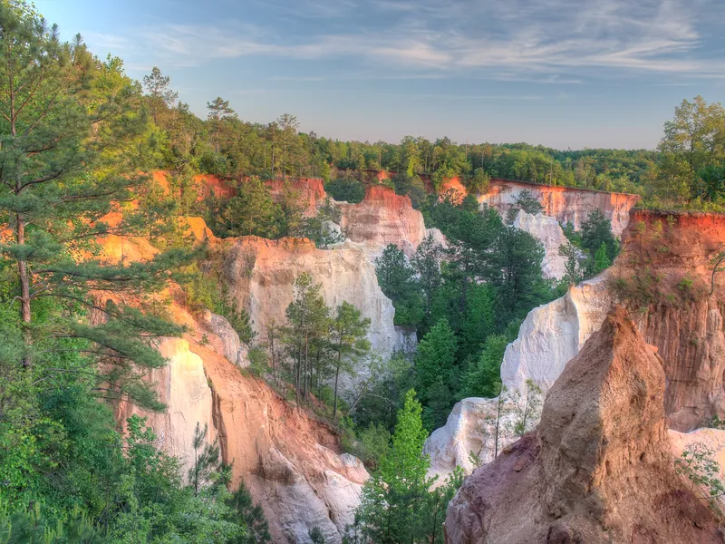 Orange, pink and white walls of Providence Canyon at sunset