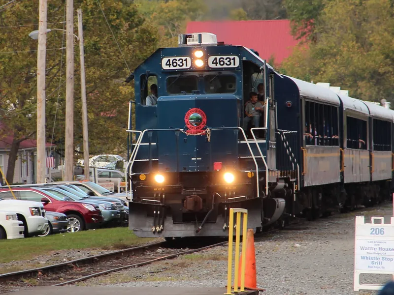 A Blue Ridge Scenic Railway engine and coaches waiting at the depot in downtown Blue Ridge