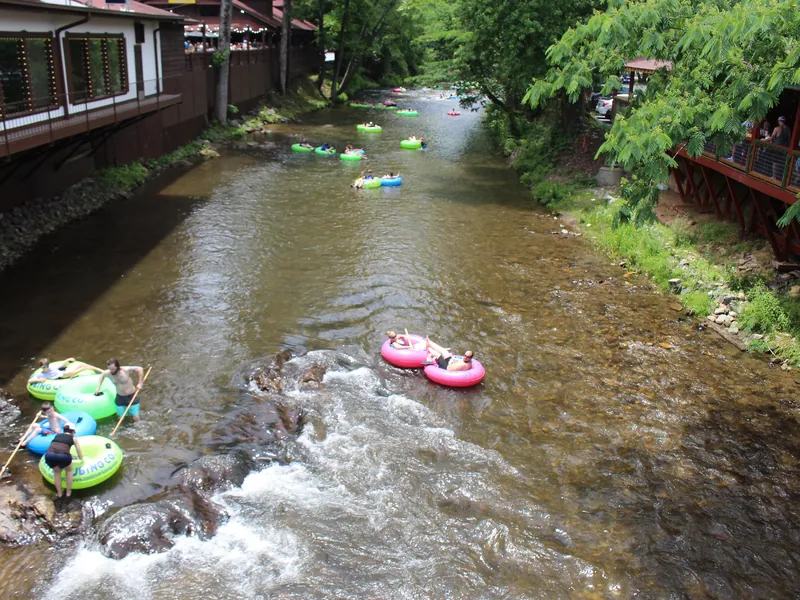 Tubers floating through a riffle on the Chattahoochee River in Helen in summer