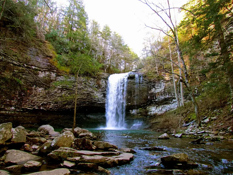Waterfall pouring into a rock-walled pool at Cloudland Canyon State Park
