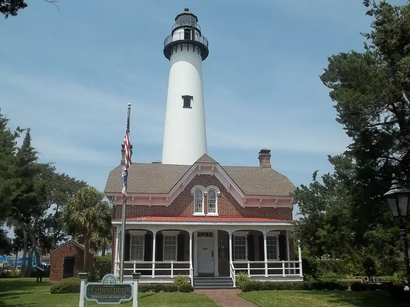 St. Simons Island Lighthouse rising behind the brick keeper&rsquo;s house