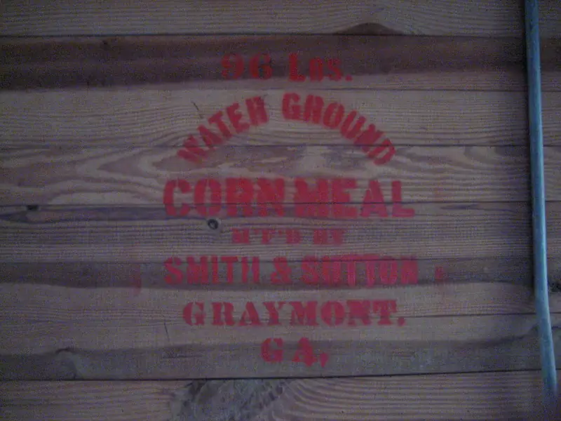 Stenciled water-ground cornmeal sign inside the Parrish grist mill at George L. Smith State Park