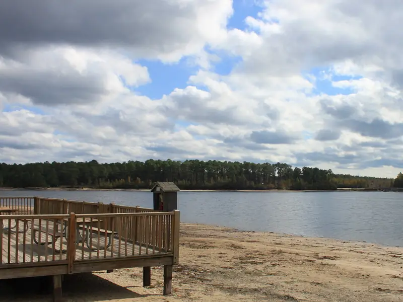 Wooden deck beside the sand beach on the lake at Laura S. Walker State Park