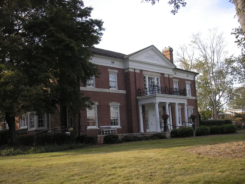 The red brick McRitchie-Hollis Museum with white columns on Jackson Street in Newnan
