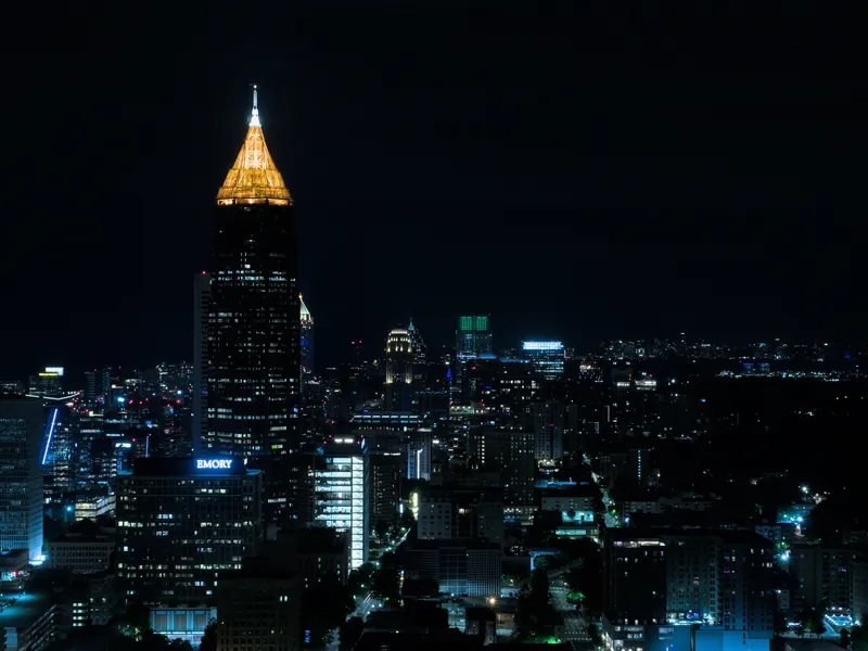 Downtown Atlanta towers lit up at night, seen from a high hotel window