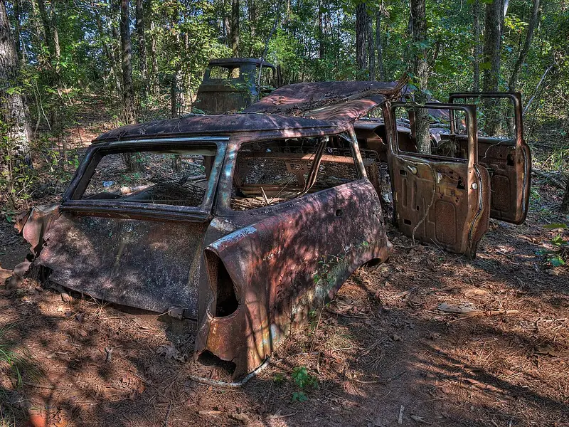 Rusted abandoned car in the woods at Providence Canyon State Park