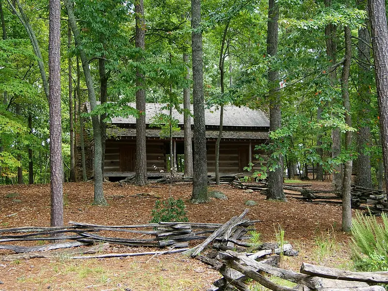 Log cabin with a split-rail fence at Red Top Mountain State Park