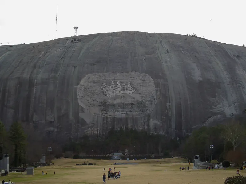 The steep granite face of Stone Mountain above the lawn at the base