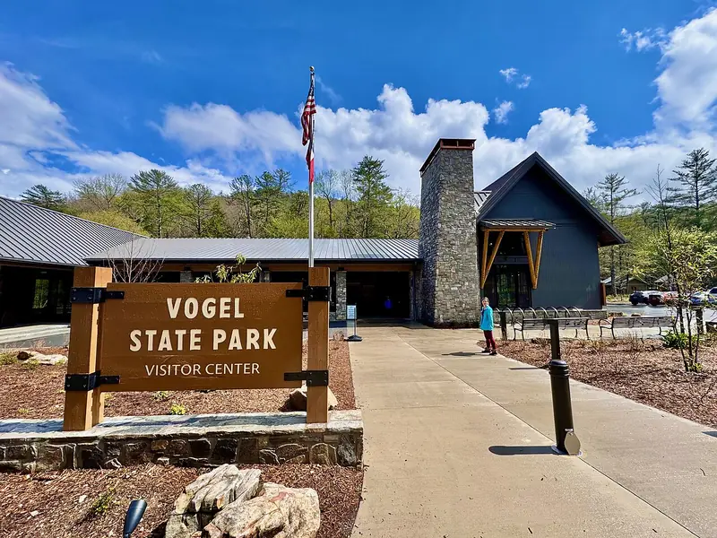 Stone-and-timber visitor center and sign at Vogel State Park