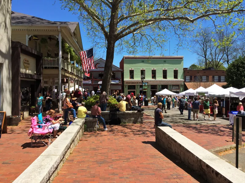 Shoppers and tents on the brick public square in downtown Dahlonega on a sunny day