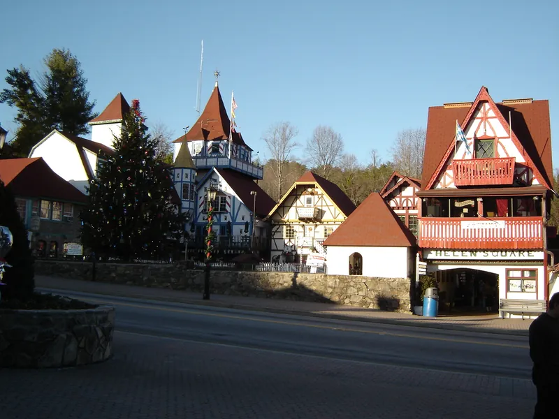 A tall evergreen and Bavarian-style buildings in the town square in Helen