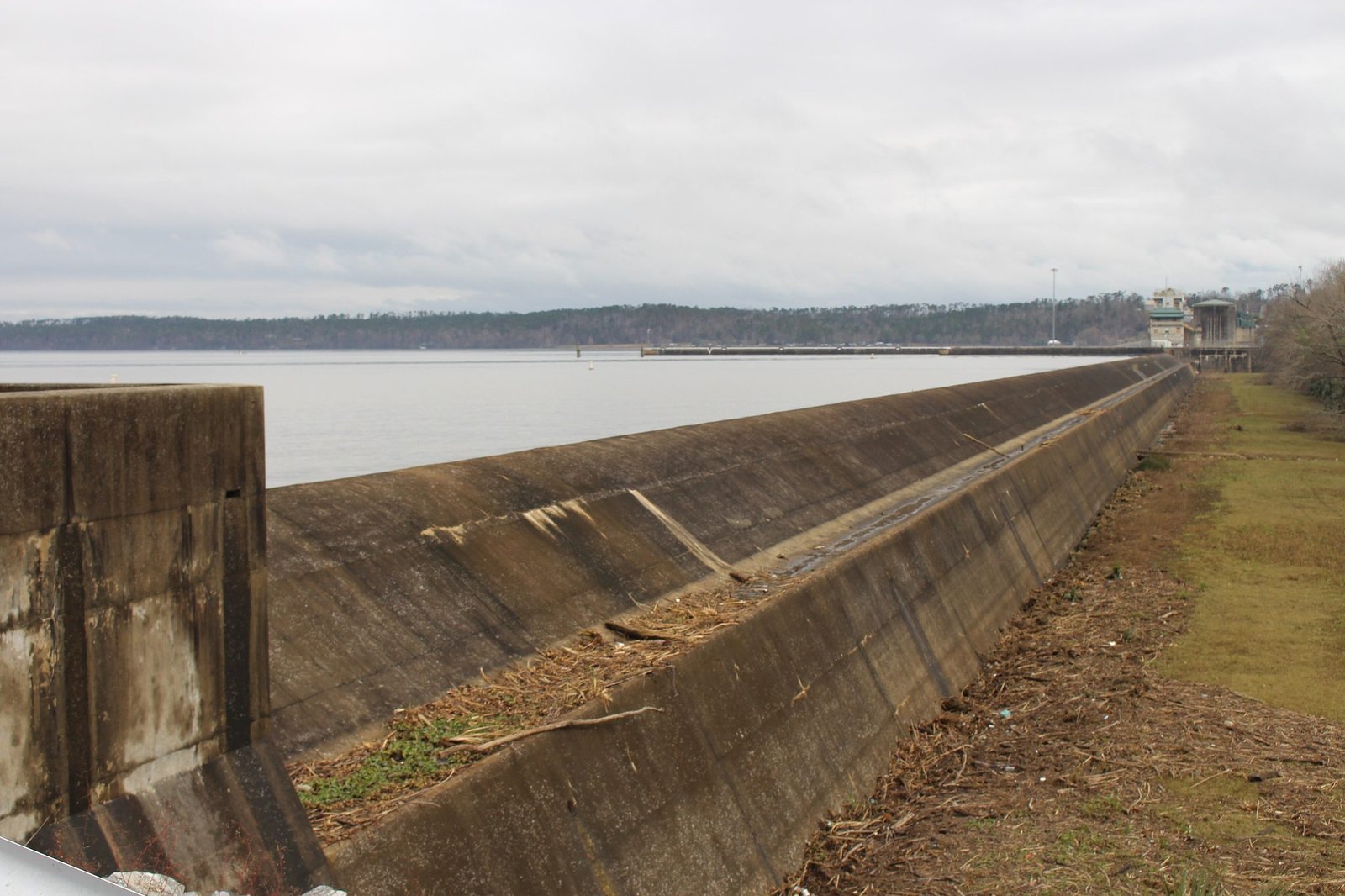Lake Seminole stretching to the horizon beside the concrete wall at Jim Woodruff Dam
