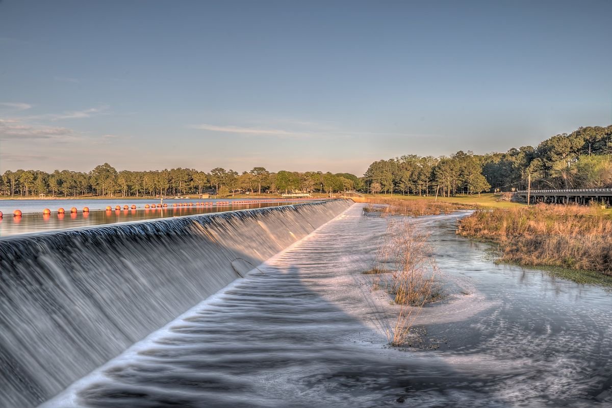 Water spilling over the dam at sunset at Reed Bingham State Park