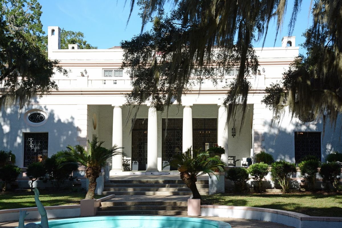 Columned white Reynolds Mansion framed by live oaks on Sapelo Island