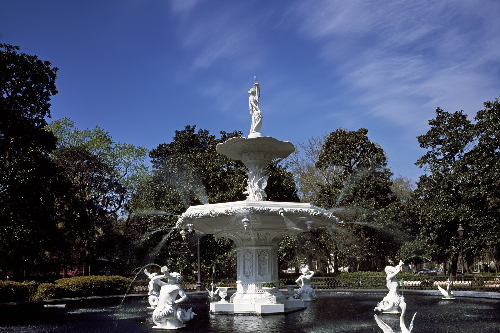 The white cast-iron fountain in Forsyth Park, Savannah, framed by live oaks