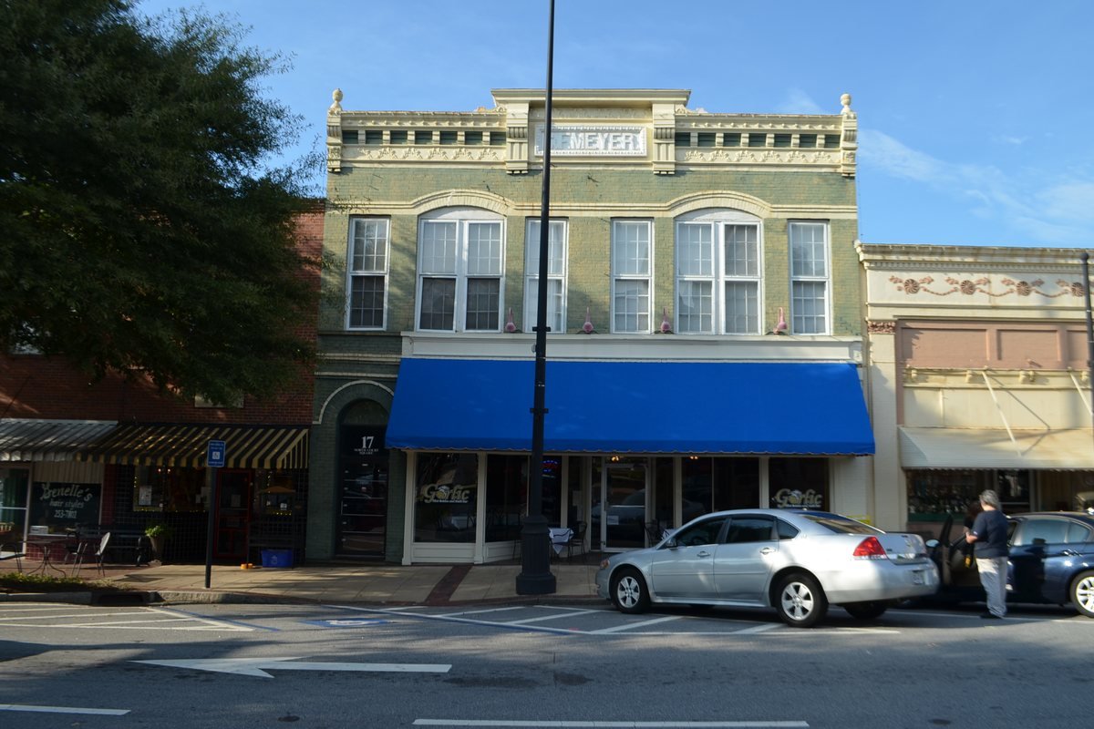 Historic brick storefronts with awnings on North Court Square in downtown Newnan, Georgia
