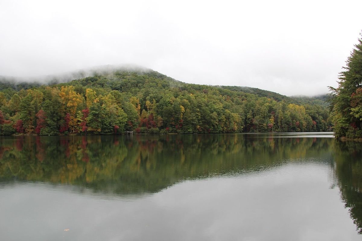 Misty lake surrounded by fall foliage at Unicoi State Park